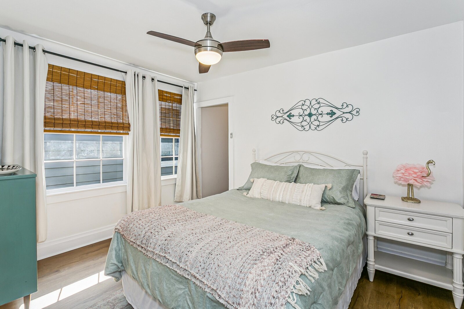 Master bedroom with sage bedding and queen bed